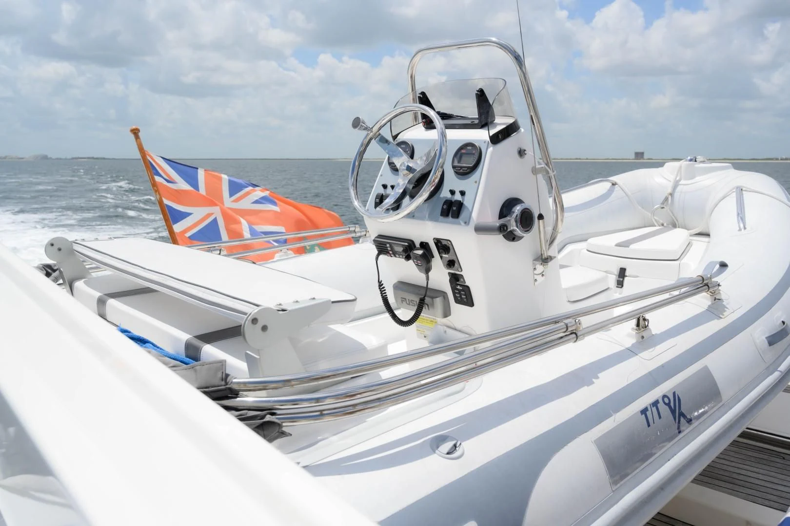 a boat with a flag on the front aboard VK Yacht for Sale