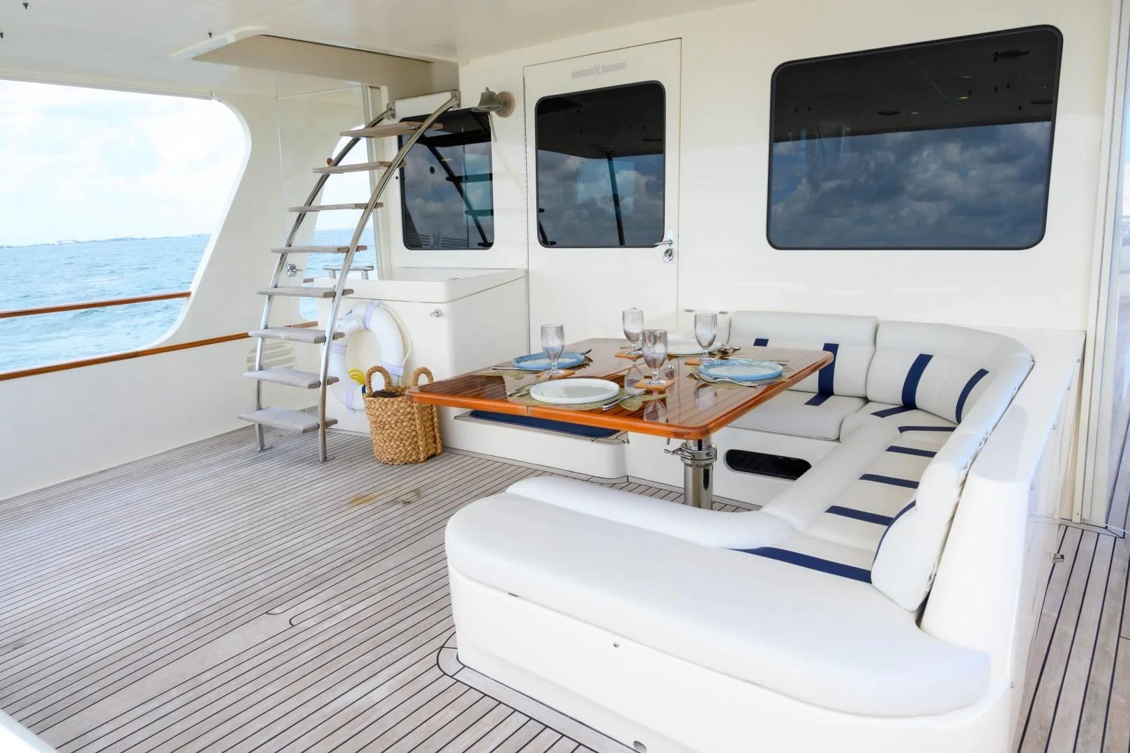 a room with a table and a tv on the wall aboard VK Yacht for Sale