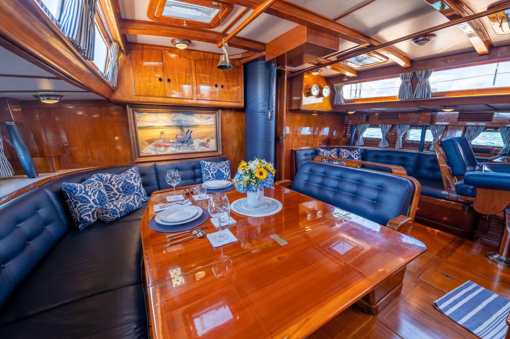 a room with leather couches and a table aboard HERMIE LOUISE Yacht for Sale