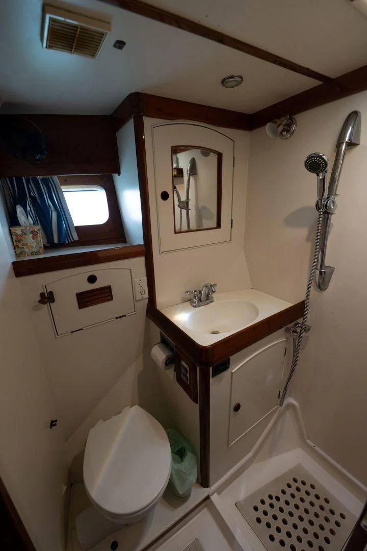 a bathroom with a toilet and sink aboard HERMIE LOUISE Yacht for Sale