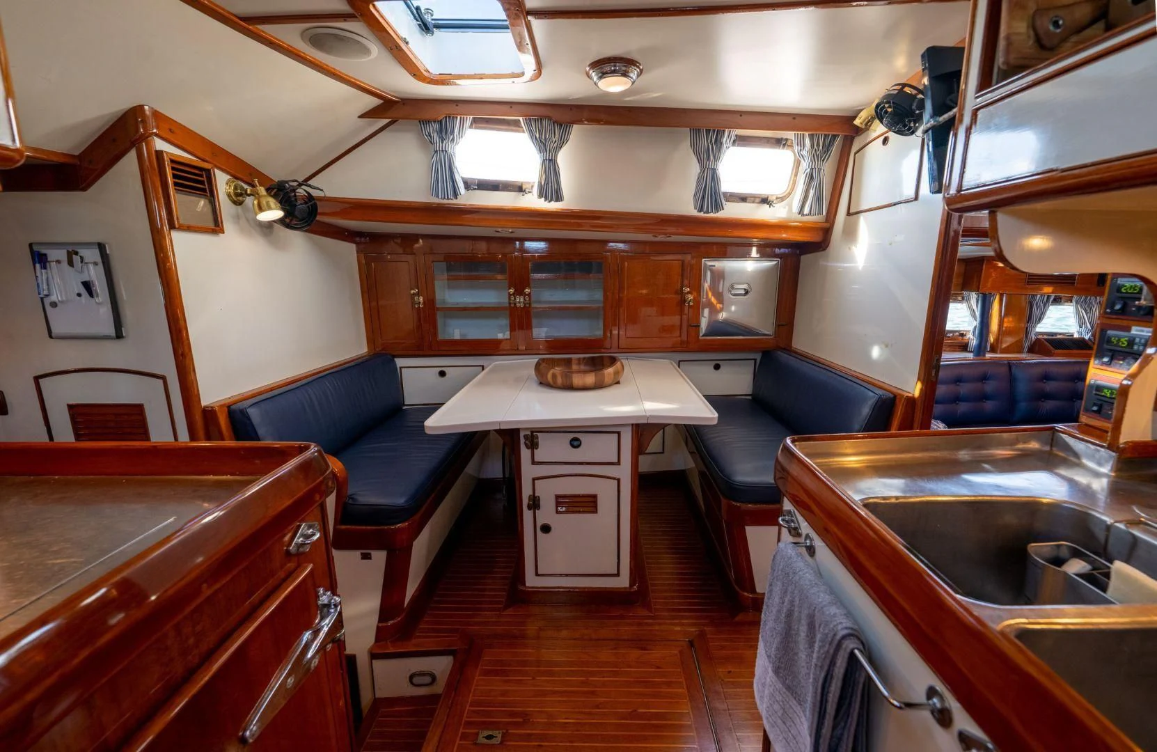 a kitchen with a couch and a sink aboard HERMIE LOUISE Yacht for Sale