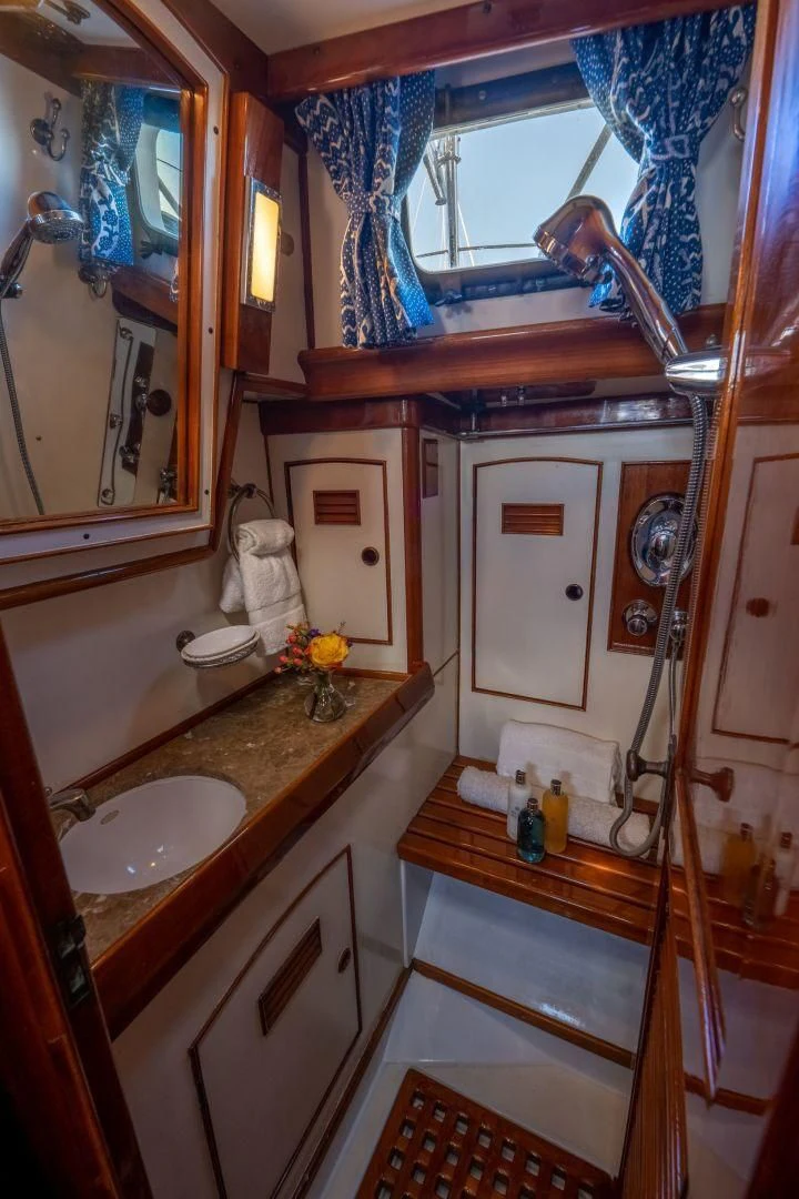 a bathroom with a sink and a mirror aboard HERMIE LOUISE Yacht for Sale