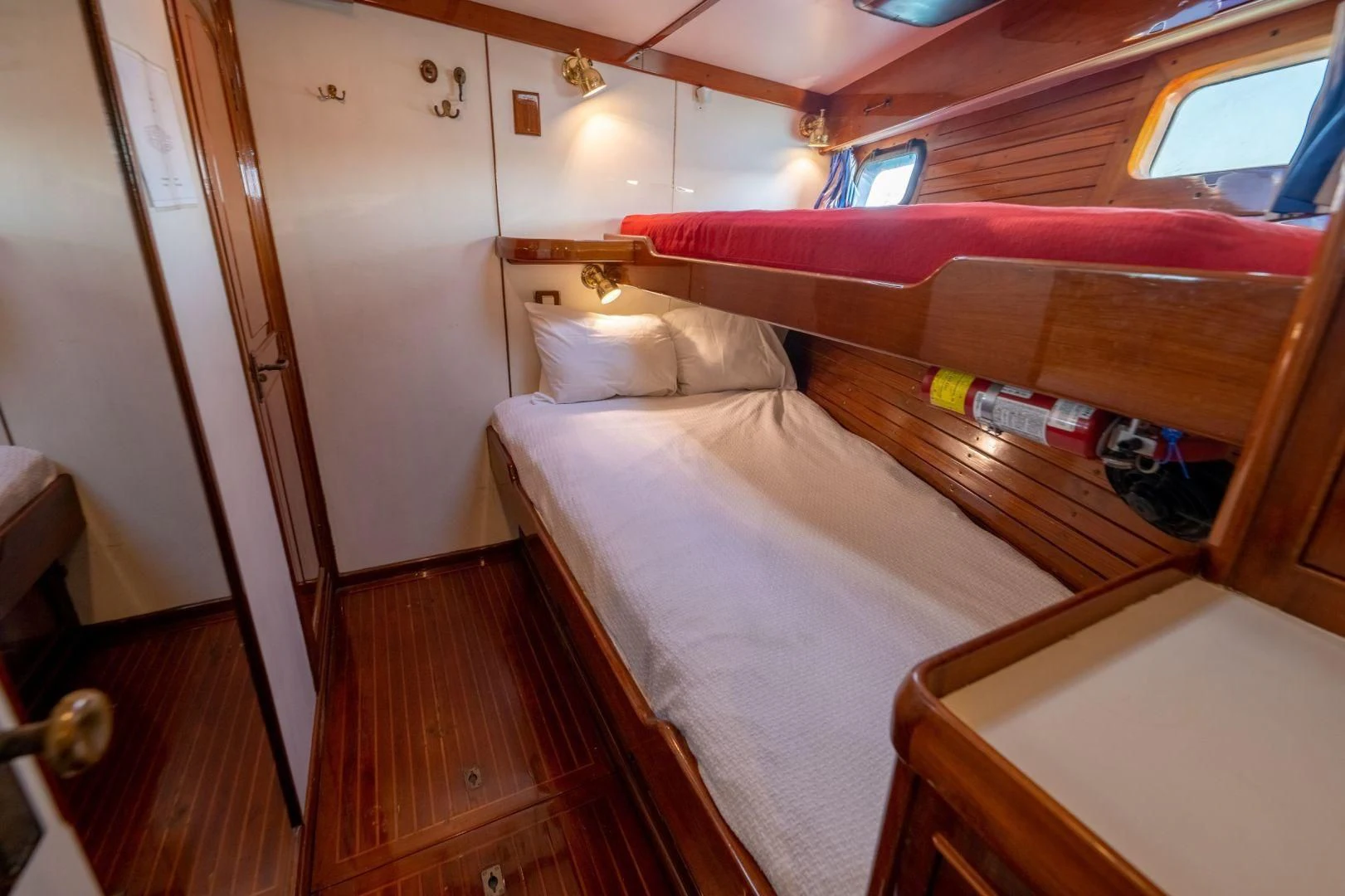 a room with a bed and a window aboard HERMIE LOUISE Yacht for Sale