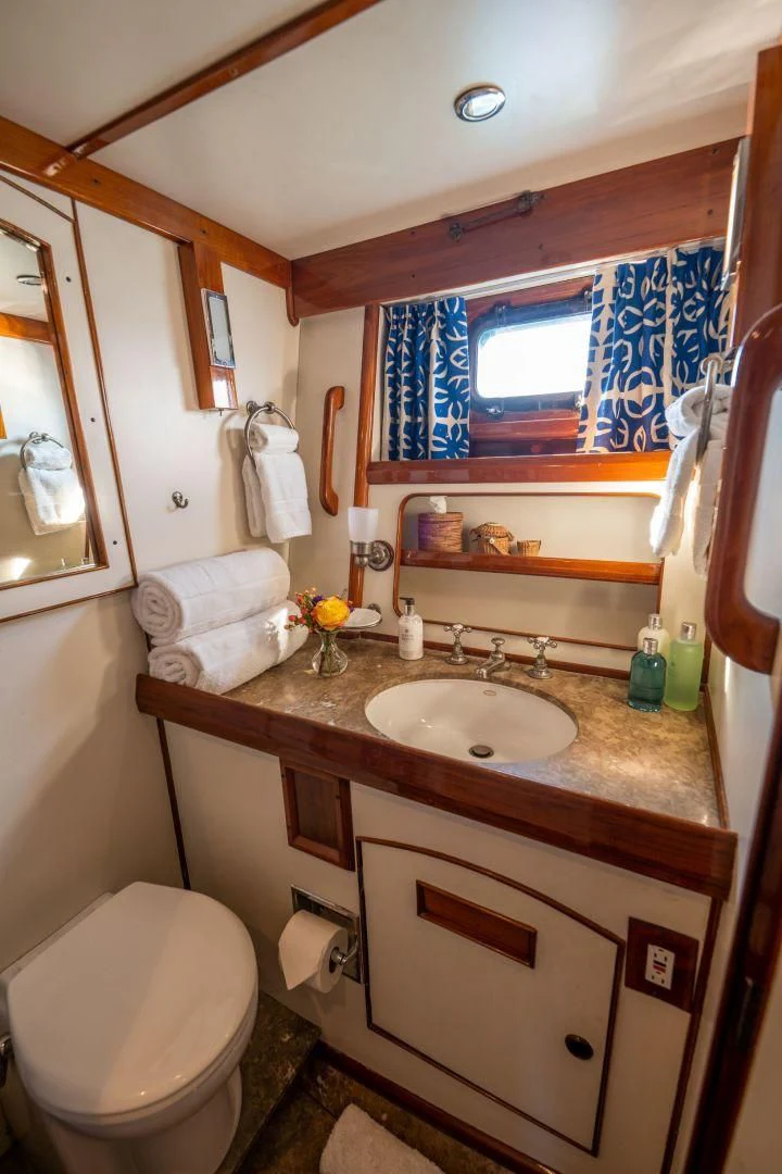 a bathroom with a sink and toilet aboard HERMIE LOUISE Yacht for Sale