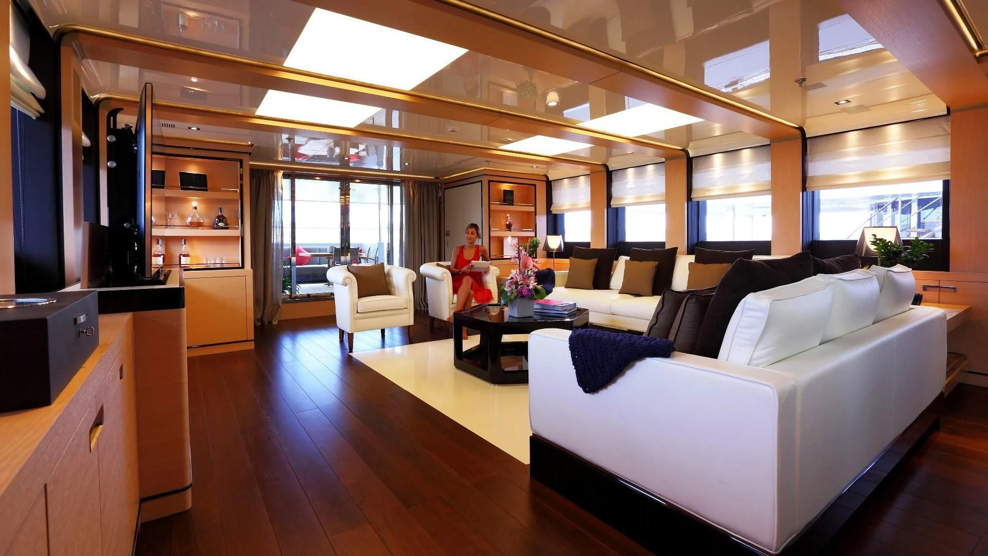 a room with a couch and a table and a person in a red dress aboard 2 LADIES Yacht for Sale
