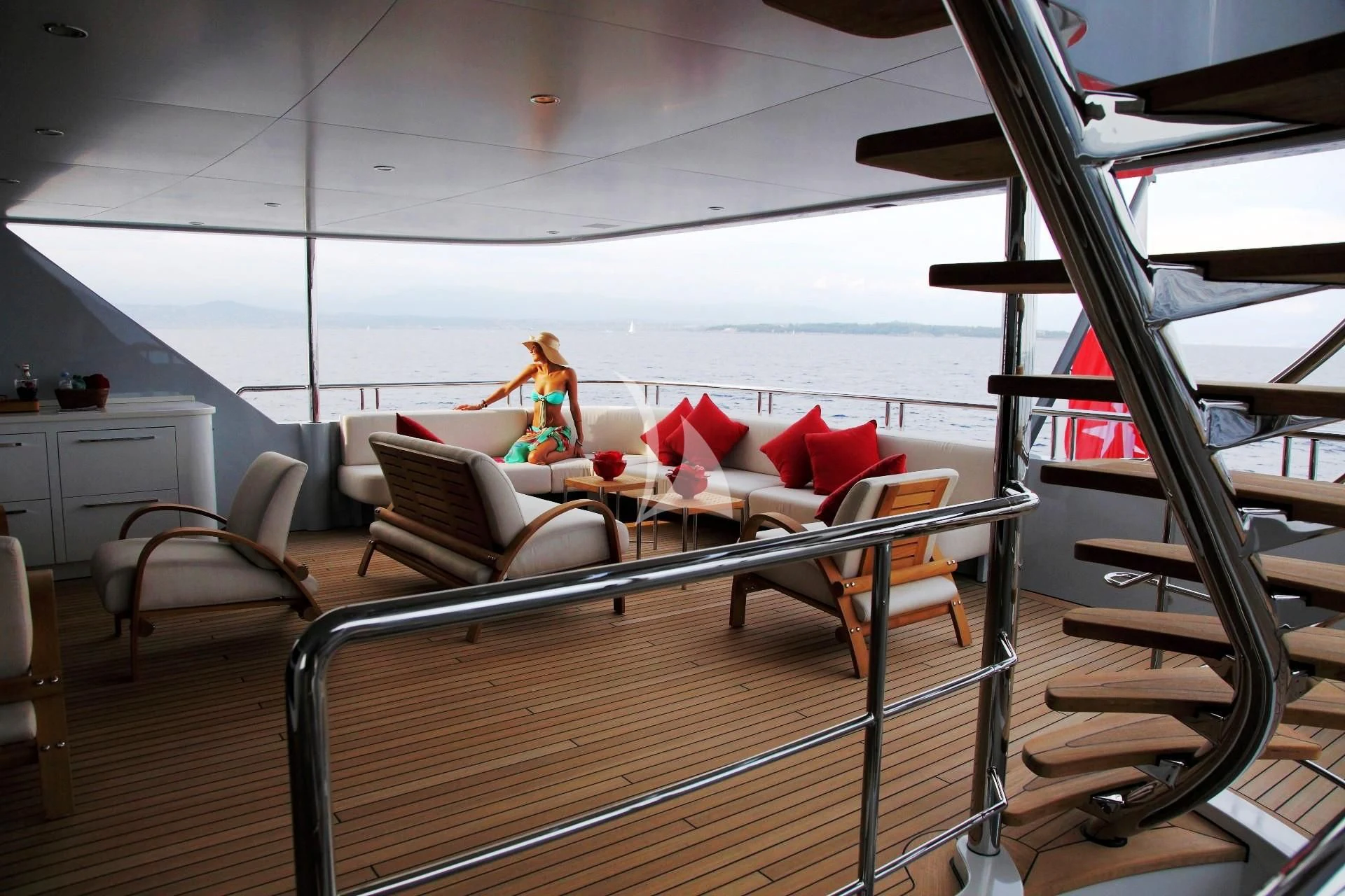 a person sitting on a bed on a balcony aboard 2 LADIES Yacht for Sale
