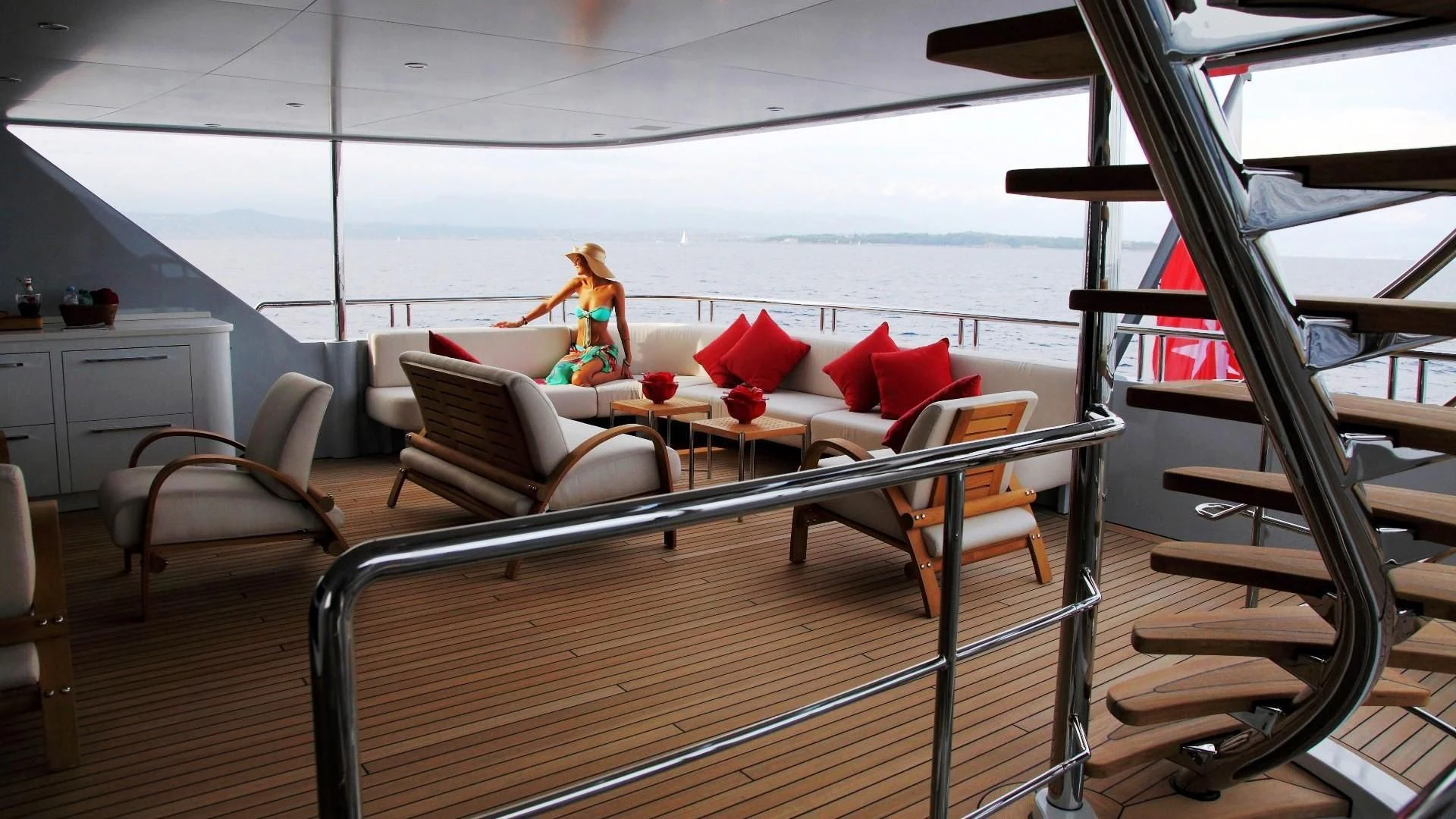 a deck with a couch and a table and chairs aboard 2 LADIES Yacht for Sale