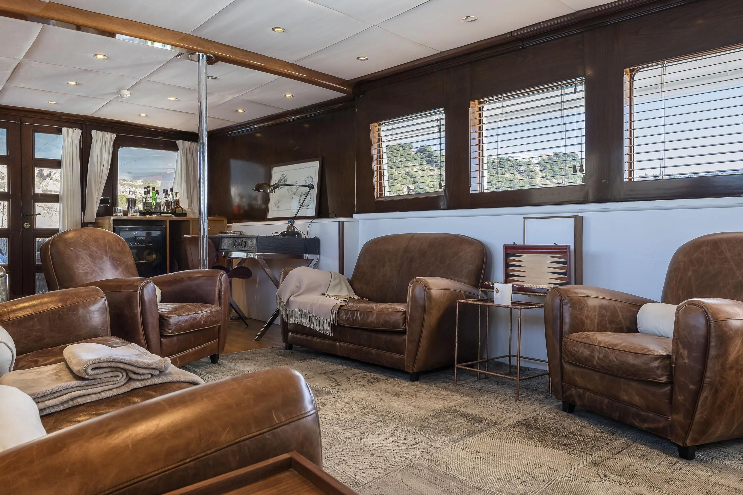 a living room with leather furniture aboard 2 LADIES Yacht for Sale