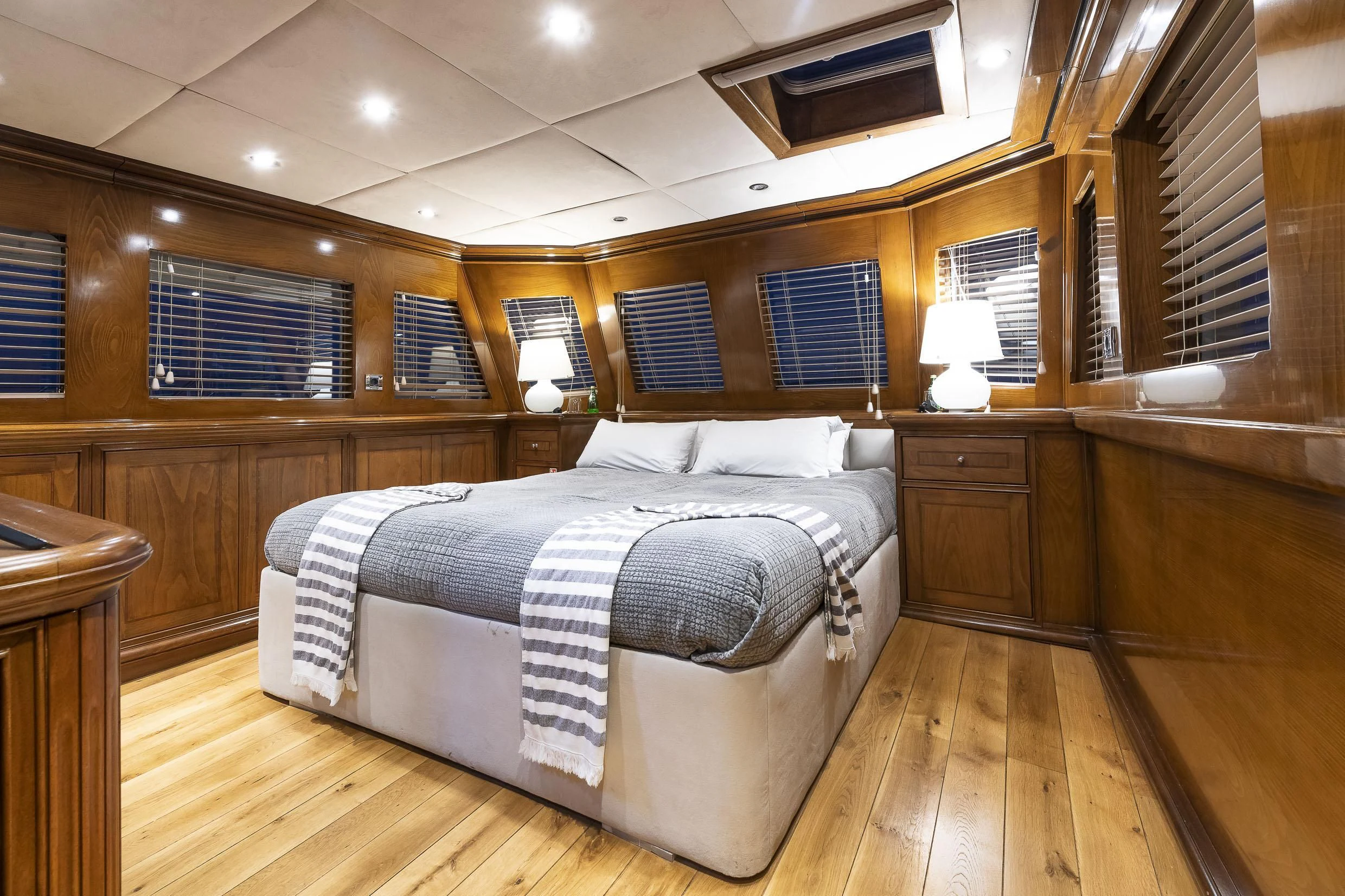 a bedroom with a bed and a window aboard 2 LADIES Yacht for Sale
