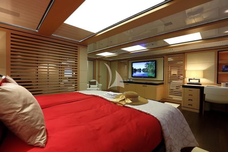 a room with a bed and a television aboard 2 LADIES Yacht for Sale