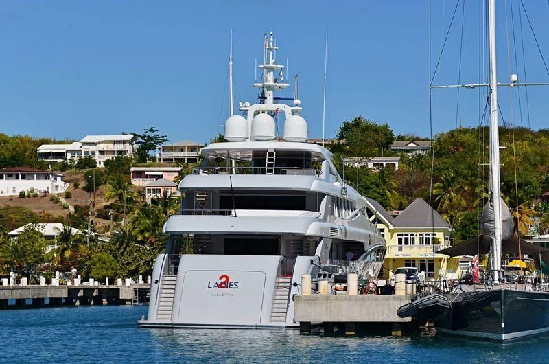 a large white boat docked at a pier aboard 2 LADIES Yacht for Sale