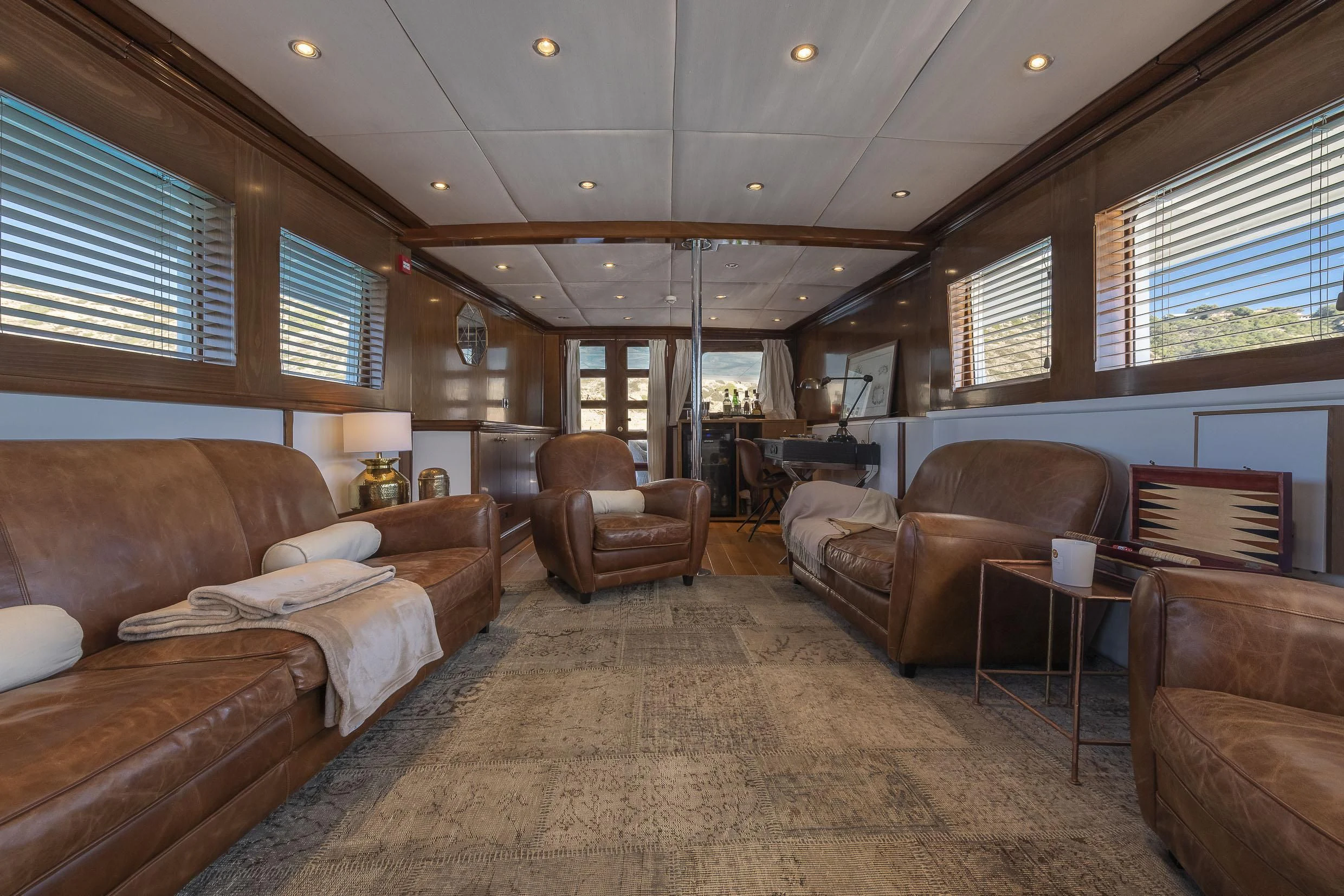 a living room with leather couches aboard 2 LADIES Yacht for Sale