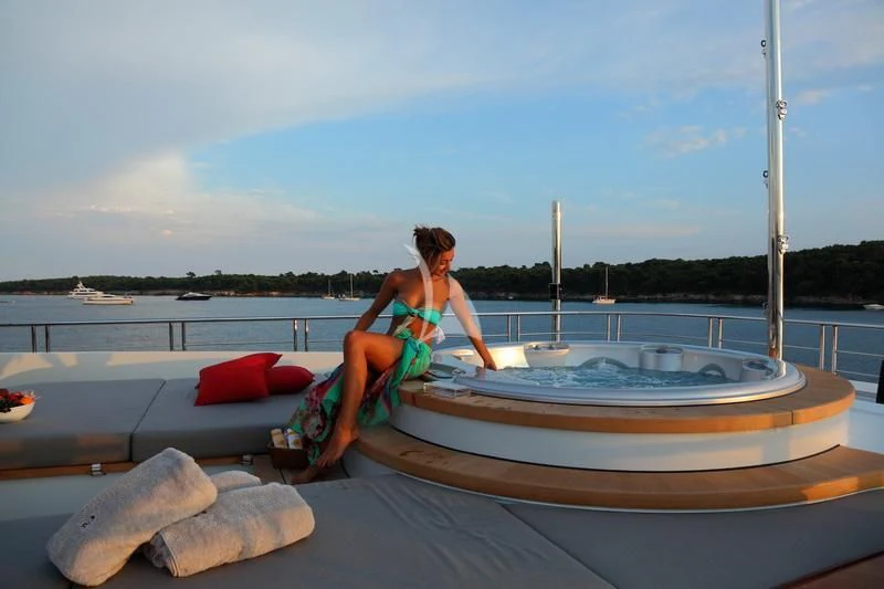 a person in a bikini sitting on a boat aboard 2 LADIES Yacht for Sale