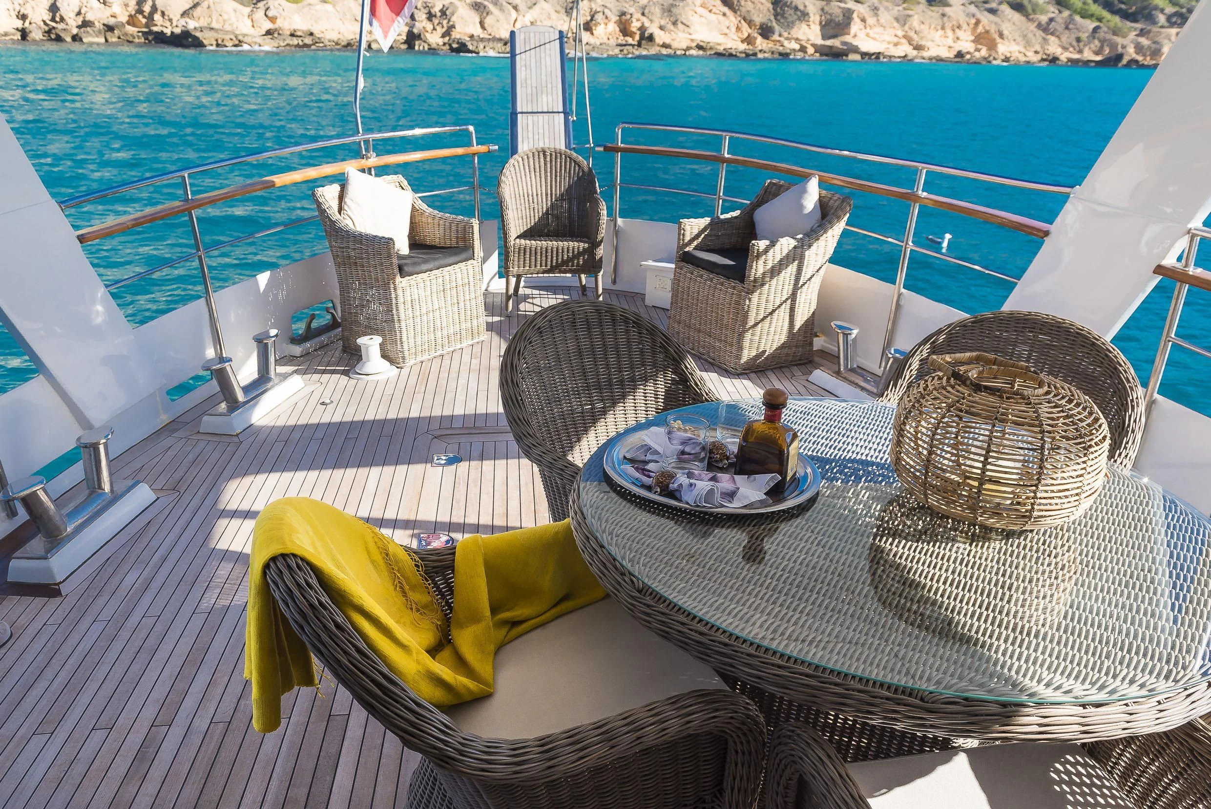 a table with chairs and a basket on it aboard 2 LADIES Yacht for Sale