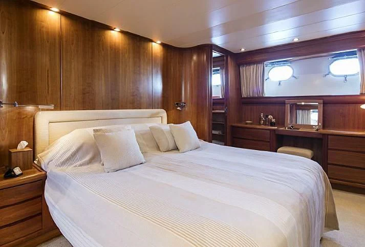 a bed with white sheets aboard VYNO Yacht for Sale