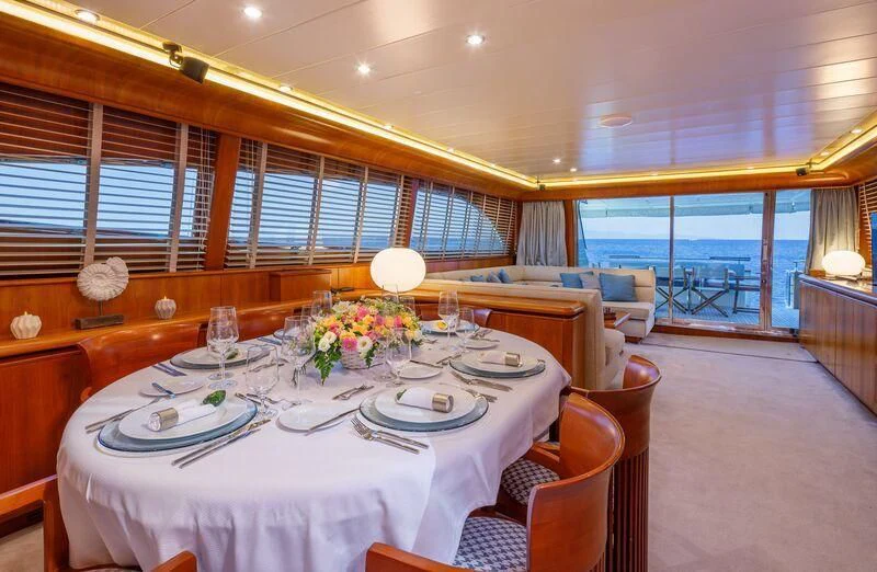 a large dining room with a large balcony aboard VYNO Yacht for Sale