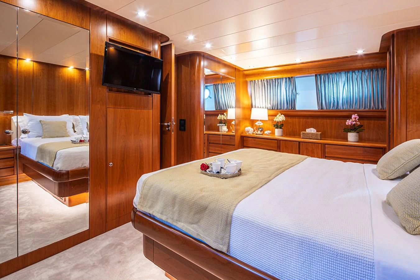 a room with a bed and a television aboard VYNO Yacht for Sale