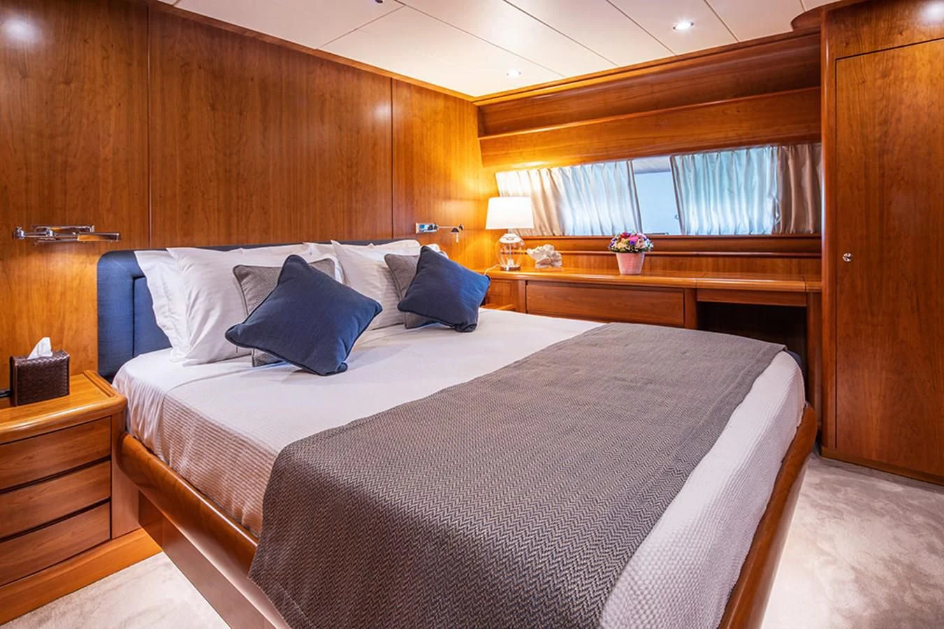 a bed with a white sheet and pillows aboard VYNO Yacht for Sale