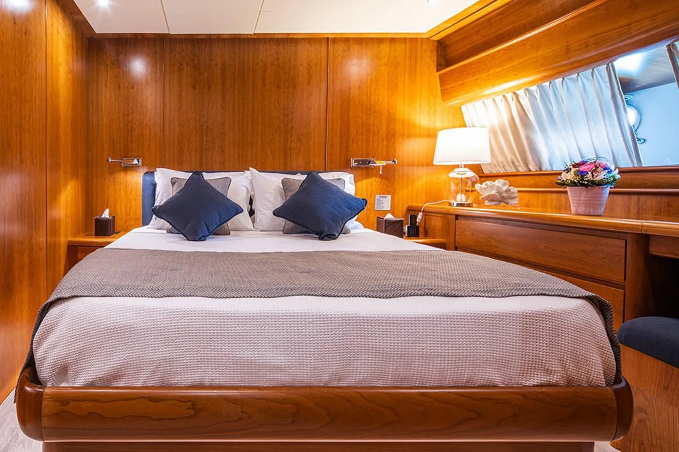 a bed with a white comforter aboard VYNO Yacht for Sale