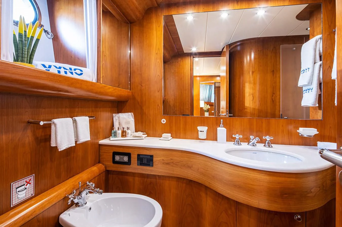 a bathroom with two sinks and a large mirror aboard VYNO Yacht for Sale