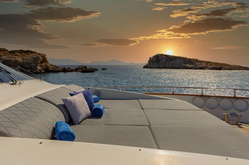 a pool with a view of the ocean and a sunset aboard VYNO Yacht for Sale
