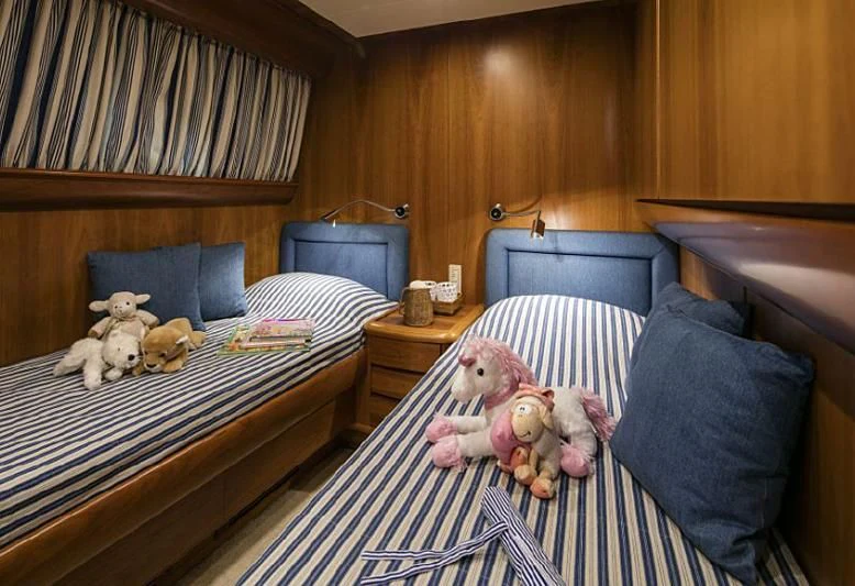 a couple of stuffed animals on a bed aboard VYNO Yacht for Sale