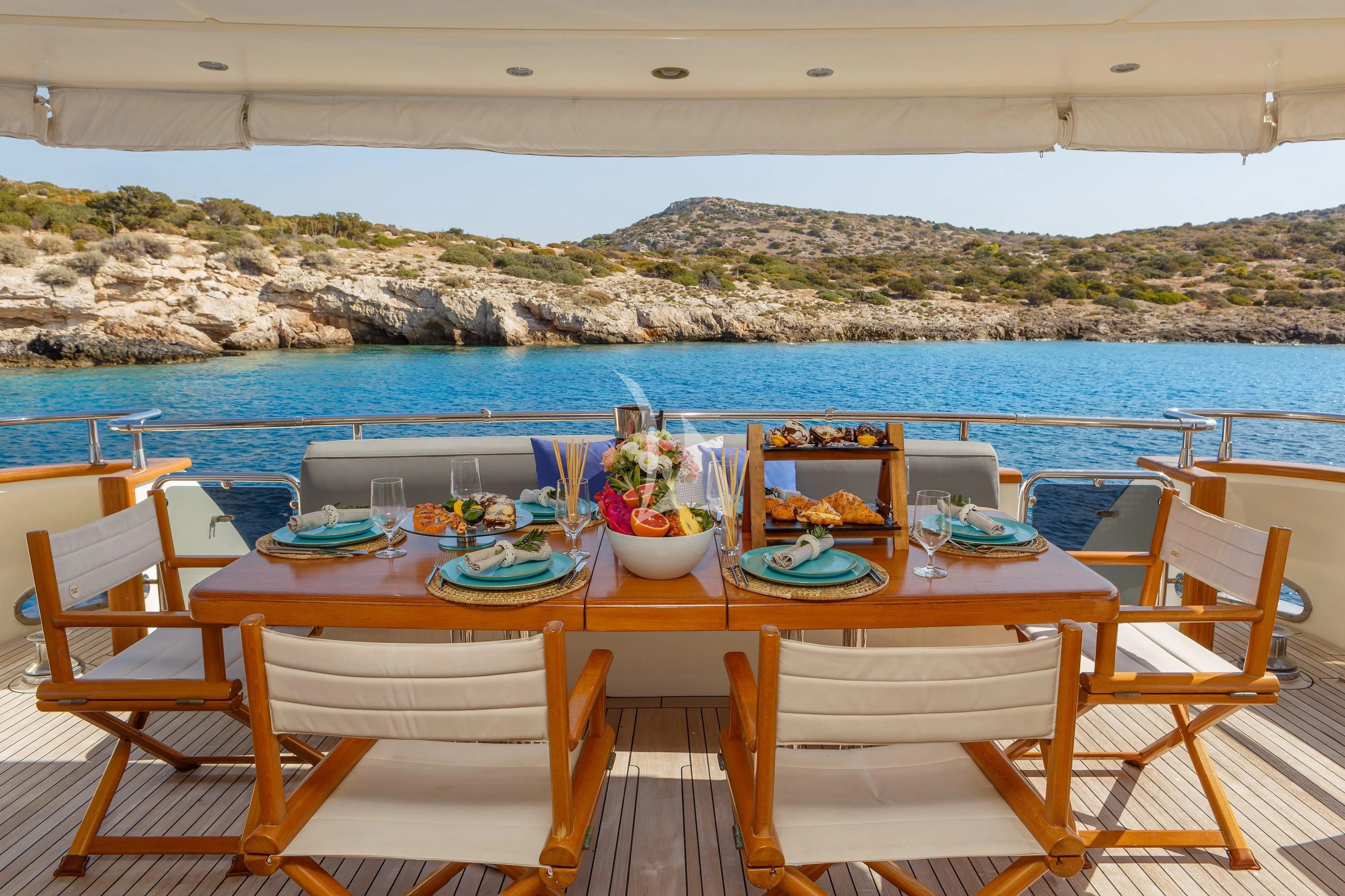a table set for a meal on a beach aboard VYNO Yacht for Sale