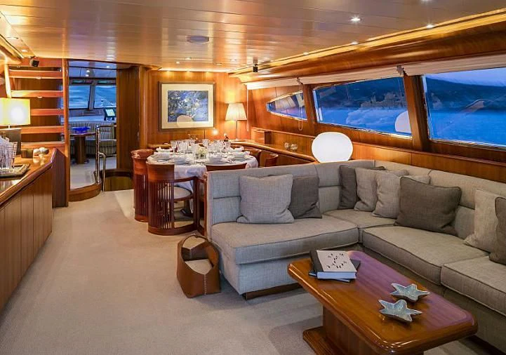 a living room with a couch and a table aboard VYNO Yacht for Sale