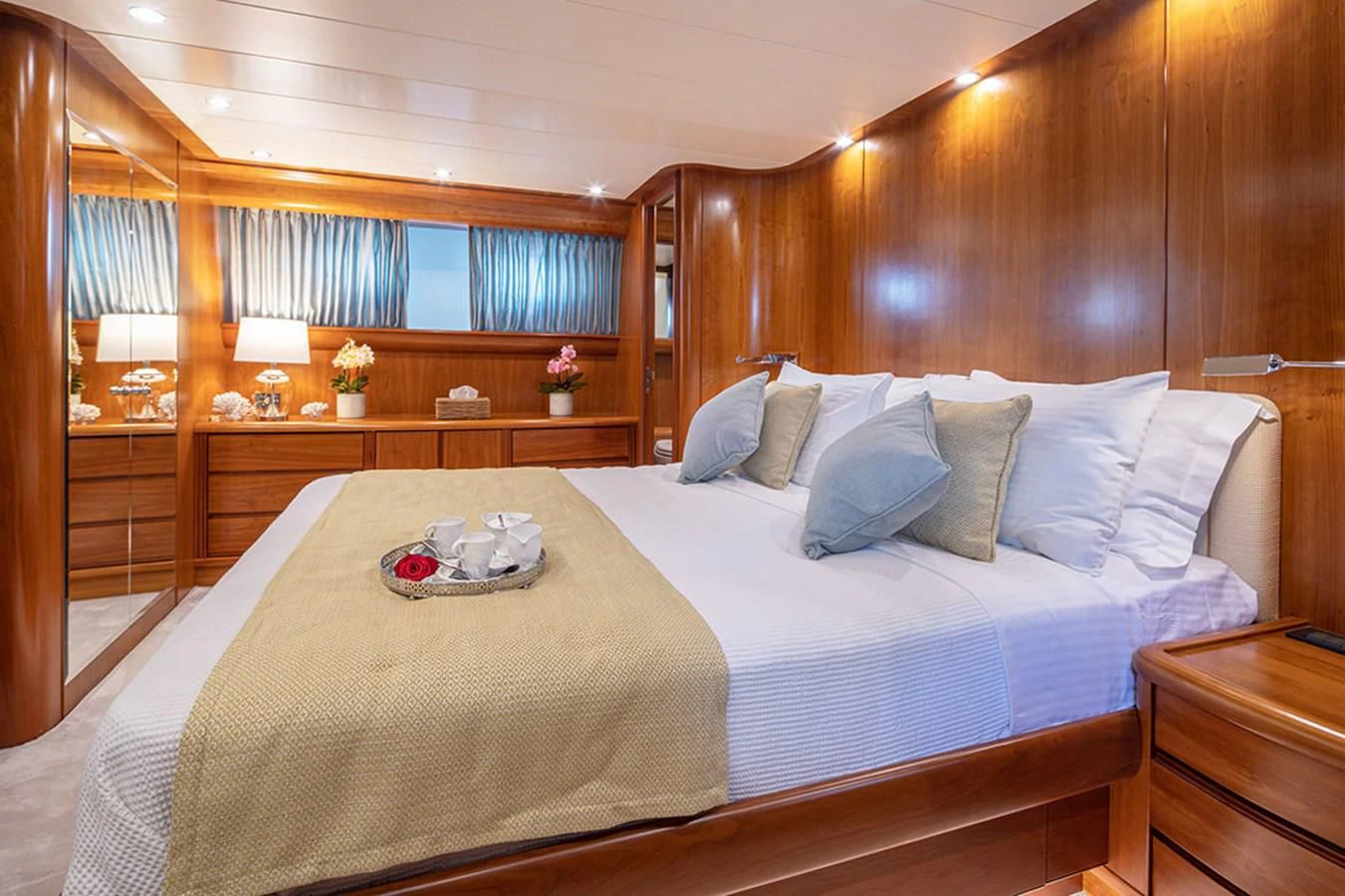 a bed with a white sheet and pillows aboard VYNO Yacht for Sale