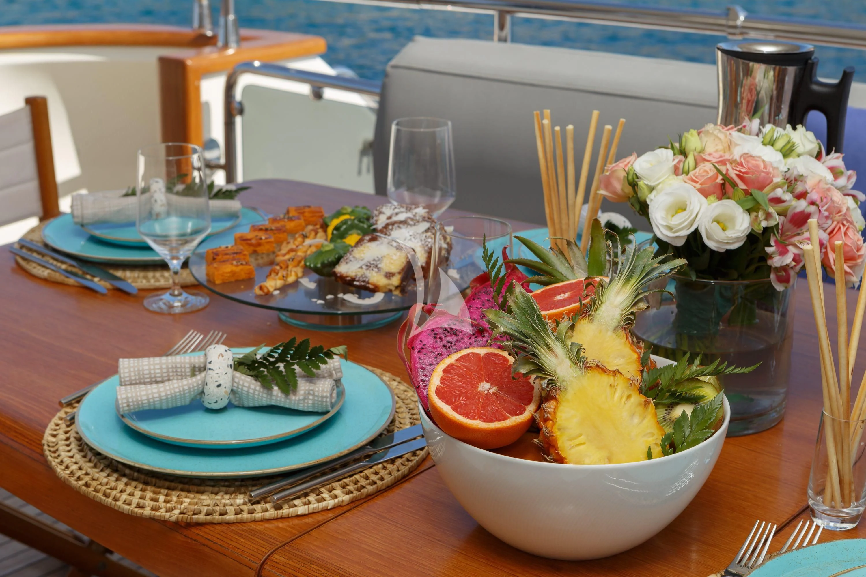 a table with food and glasses aboard VYNO Yacht for Sale