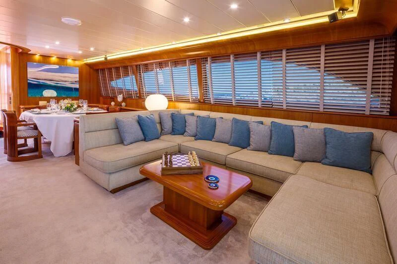 a living room with a couch and a table aboard VYNO Yacht for Sale
