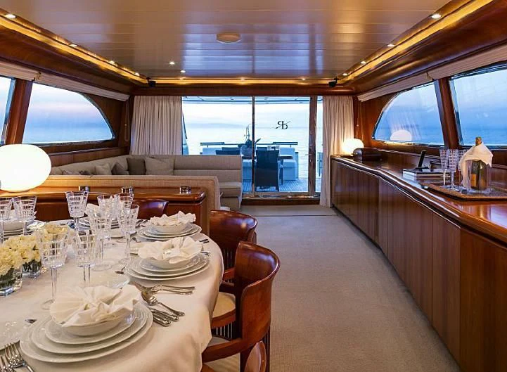 a large dining room with a large window aboard VYNO Yacht for Sale