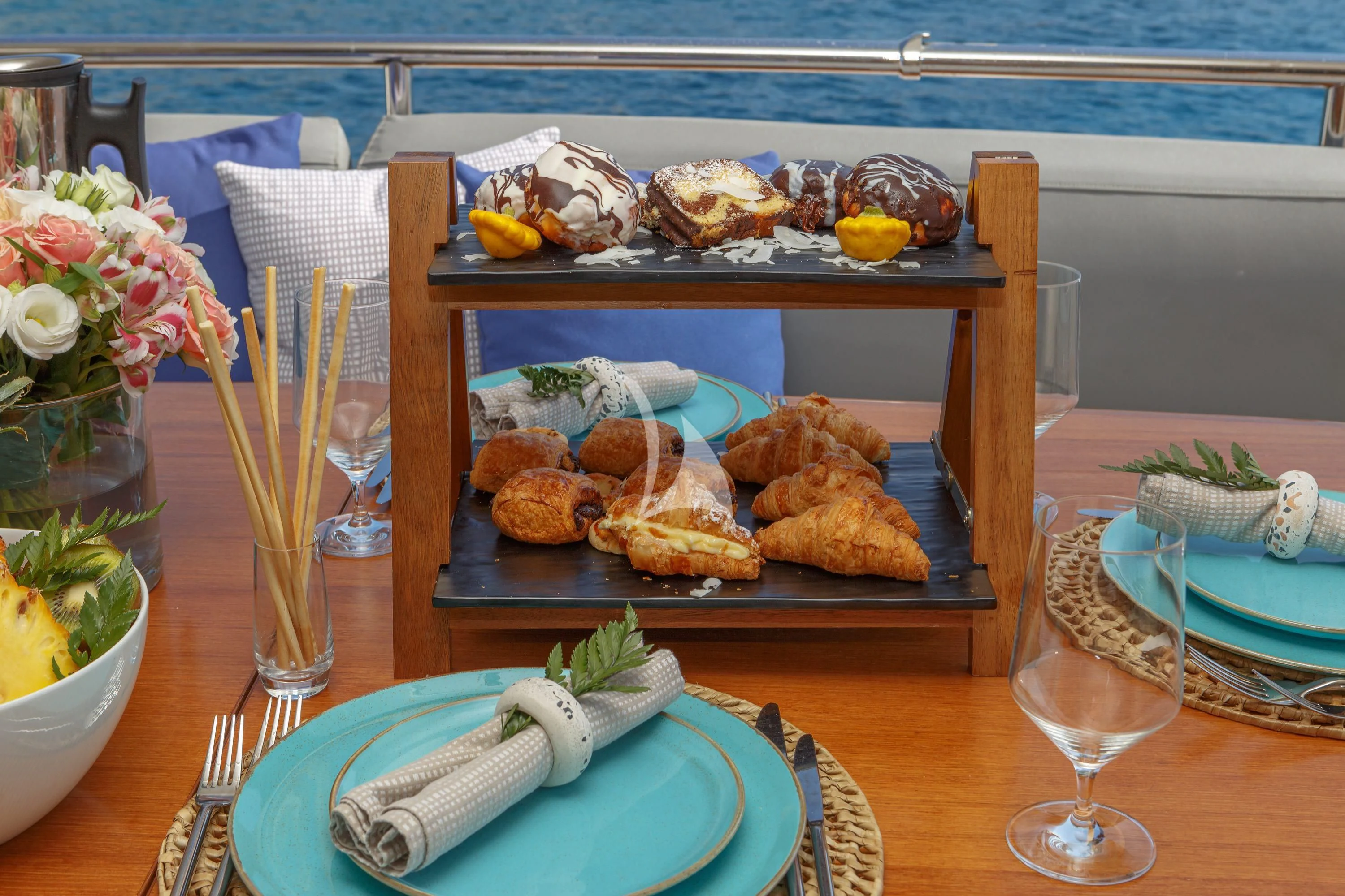 a table with food and flowers aboard VYNO Yacht for Sale