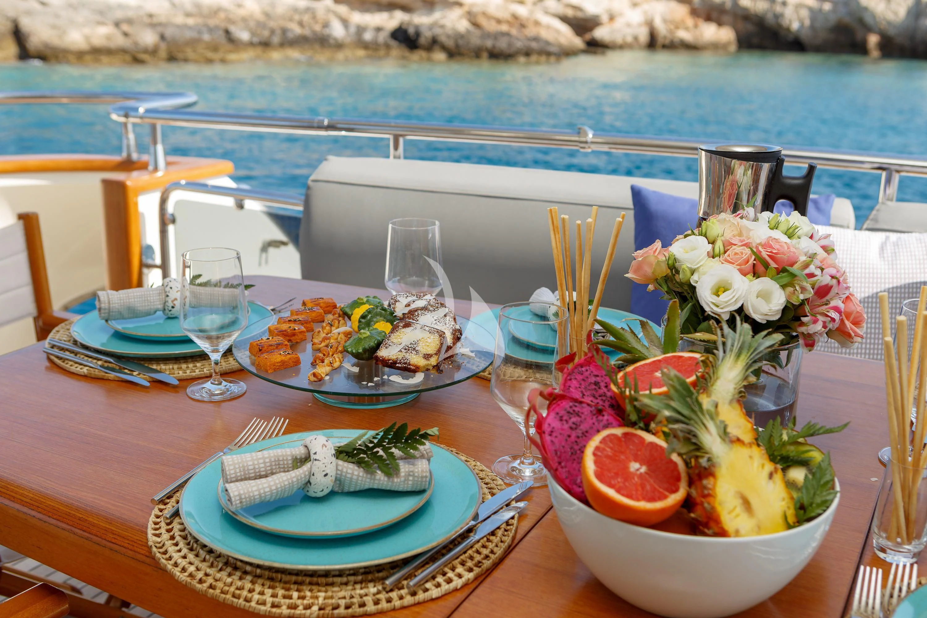a table with food and glasses on it aboard VYNO Yacht for Sale