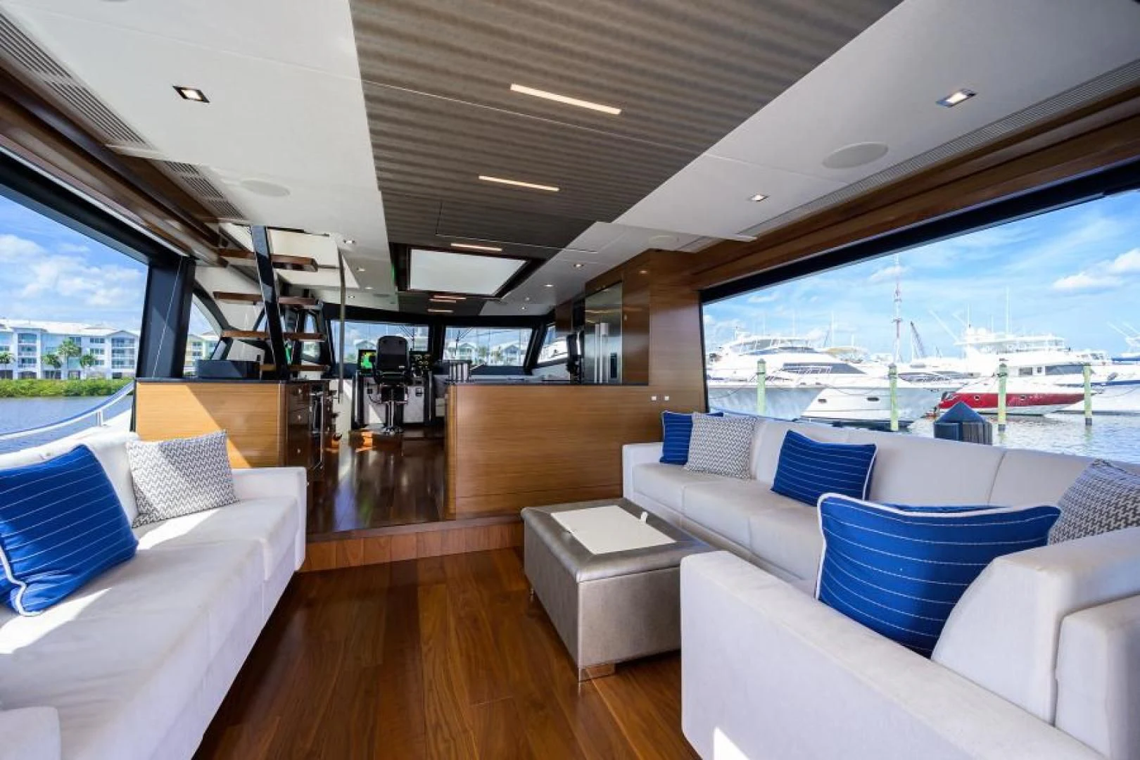 a room with couches and a large window aboard JOHN BOAT Yacht for Sale