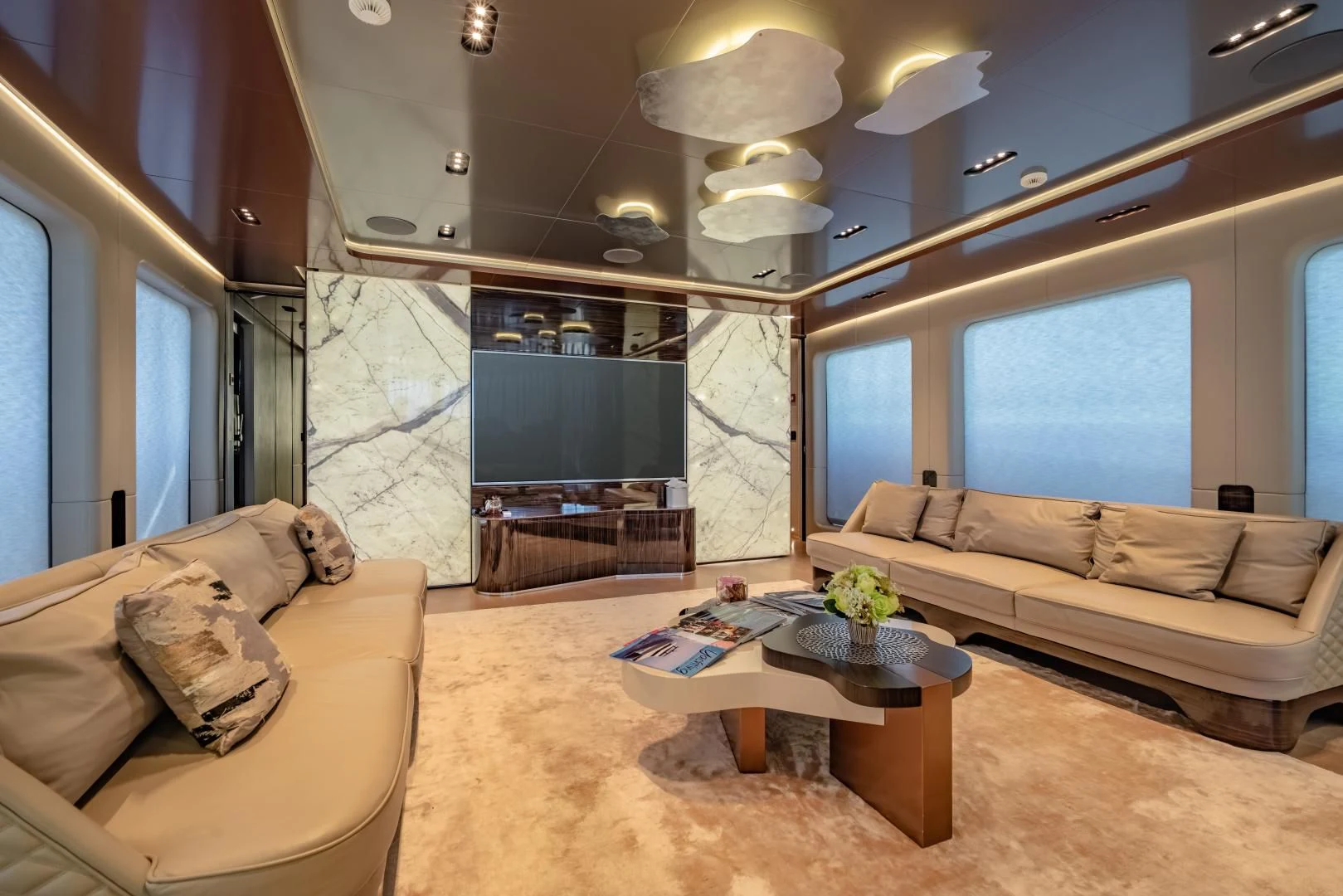 a living room with a large fireplace aboard LA VIE Yacht for Sale