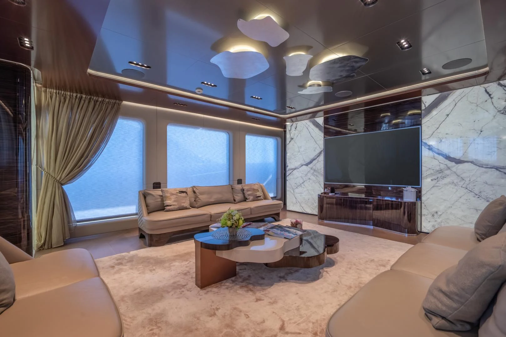 a living room with a large screen aboard LA VIE Yacht for Sale