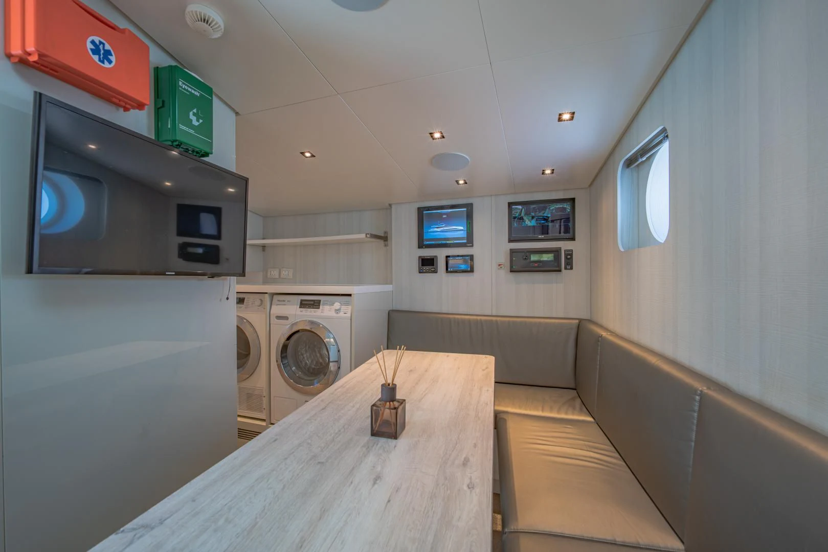 a small kitchen with a washing machine aboard LA VIE Yacht for Sale