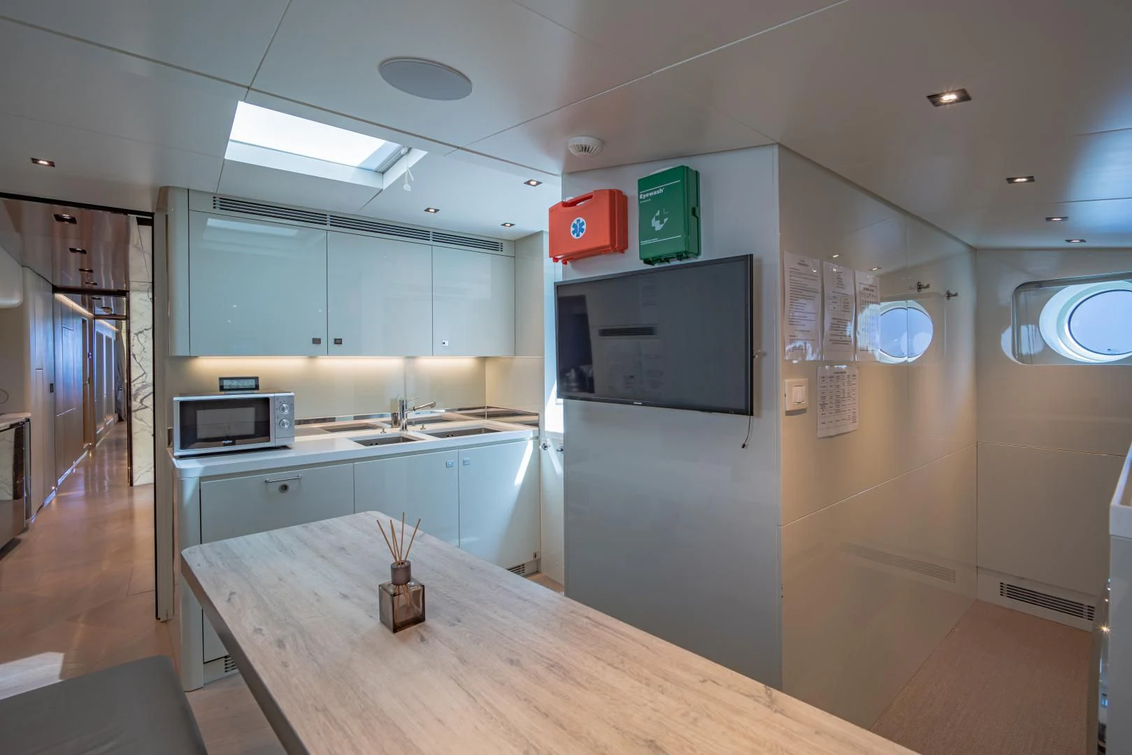 a kitchen with a table and microwave aboard LA VIE Yacht for Sale