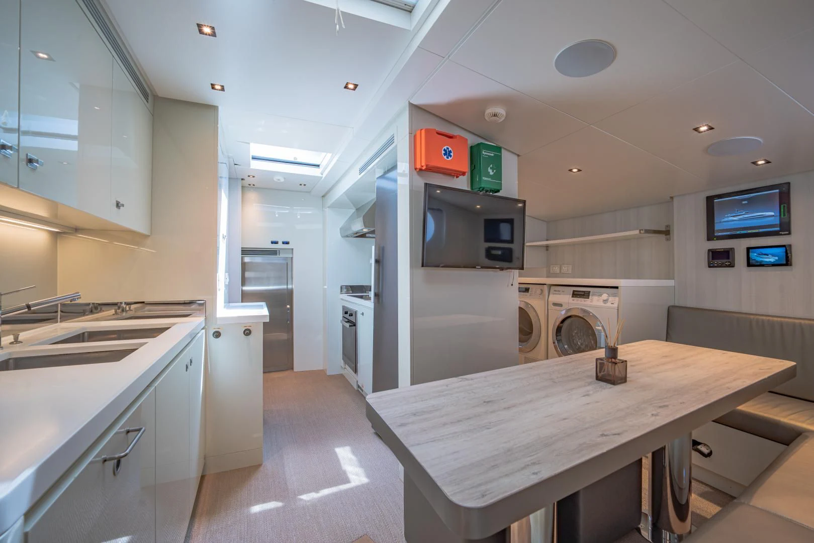 a kitchen with a table and microwave aboard LA VIE Yacht for Sale