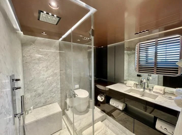 a bathroom with a glass shower aboard LA VIE Yacht for Sale