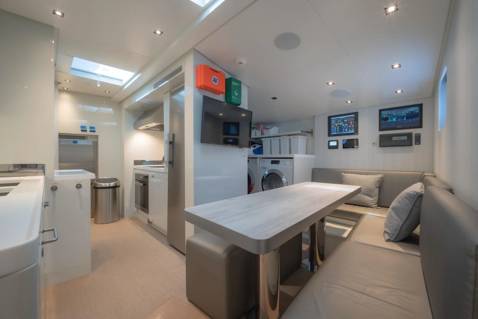 a living room with a table and couches aboard LA VIE Yacht for Sale