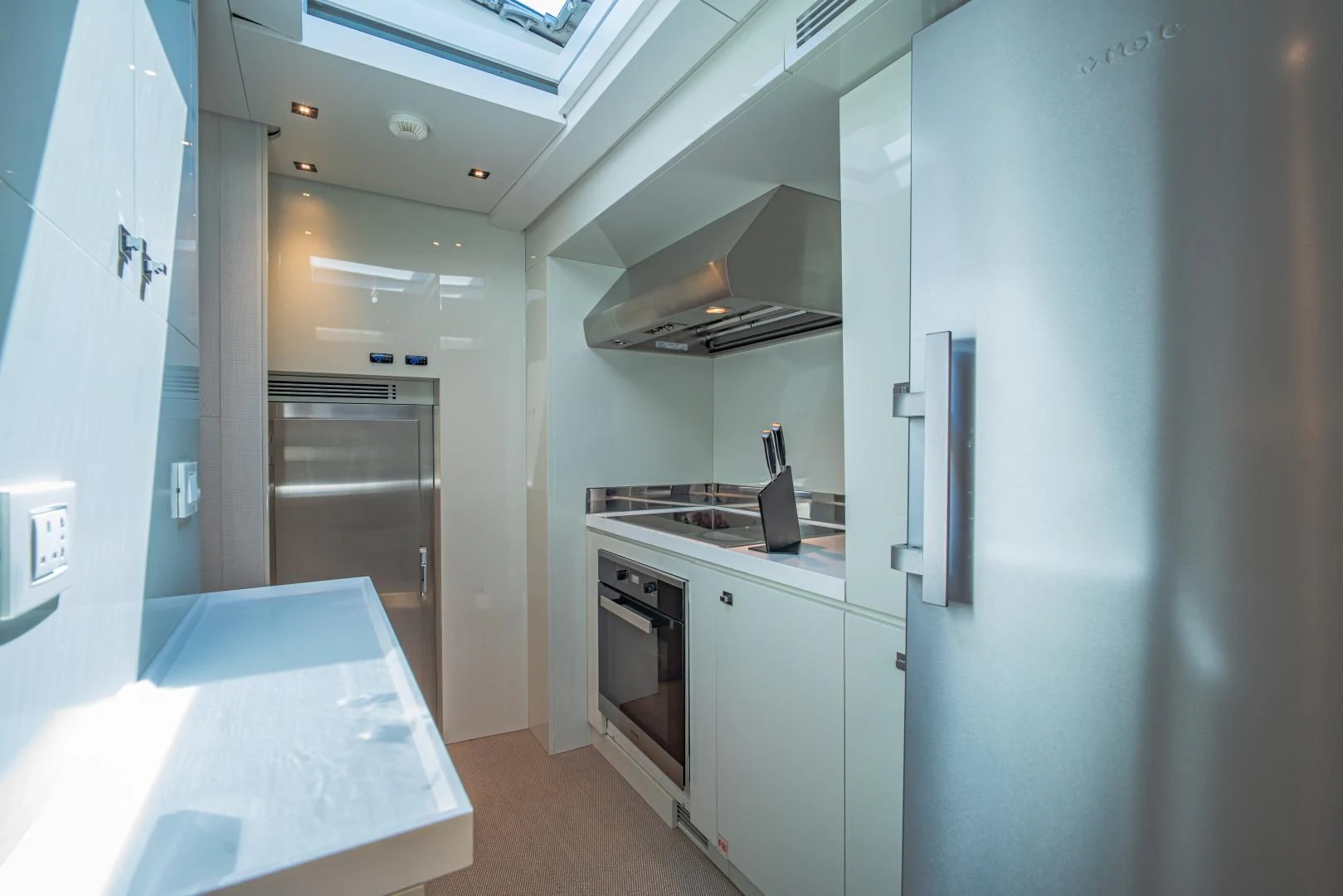 a kitchen with white cabinets aboard LA VIE Yacht for Sale