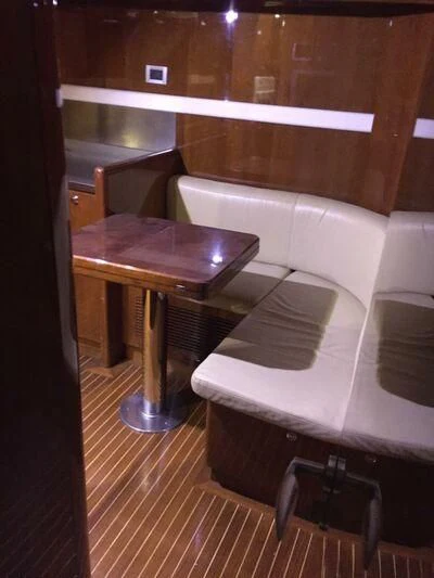 a room with a table and chairs aboard AEGINA Yacht for Sale