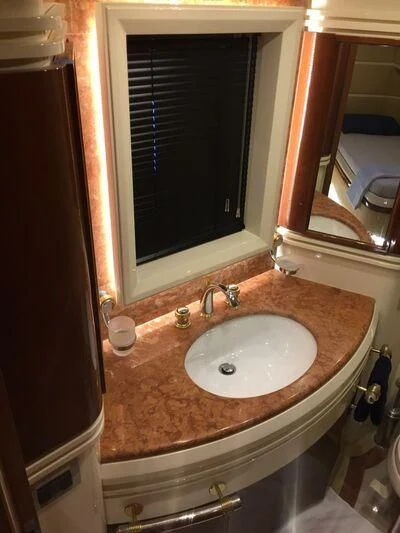a bathroom sink with a large mirror aboard AEGINA Yacht for Sale