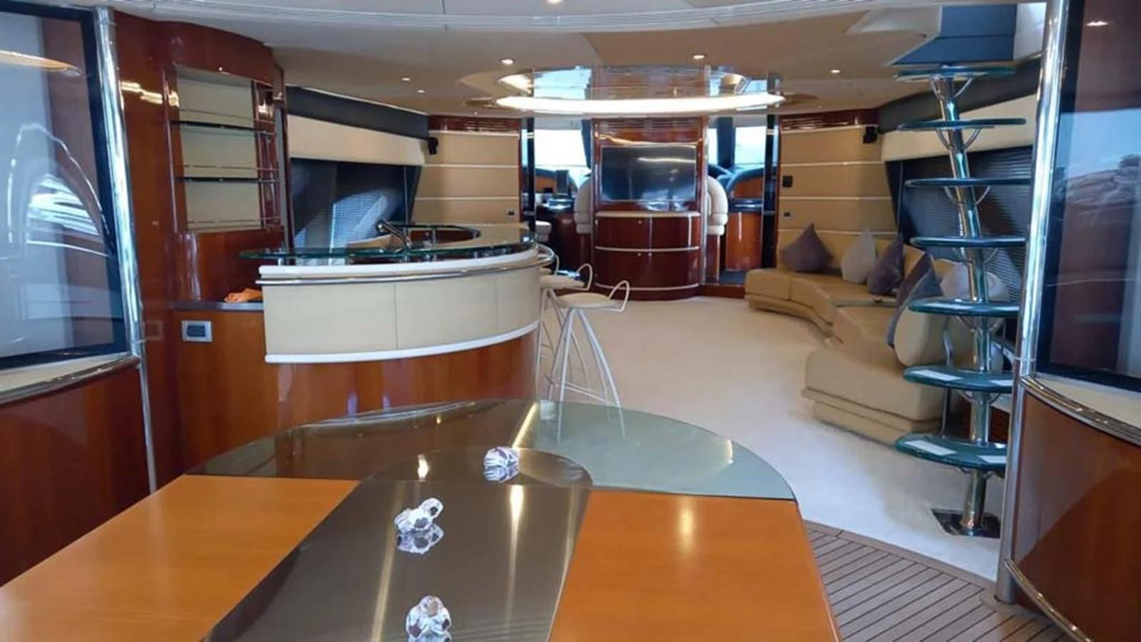 a room with a table and a tv aboard AEGINA Yacht for Sale