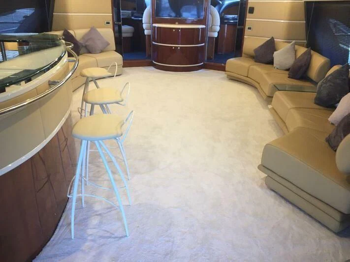 a living room with a couch and a table aboard AEGINA Yacht for Sale