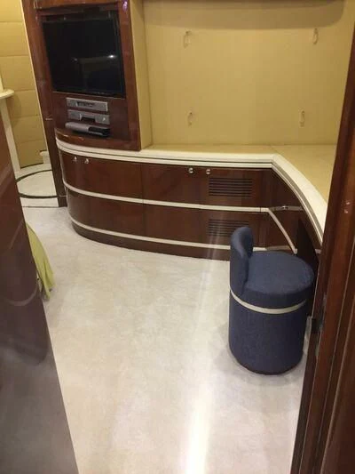 a black and white chair next to a wooden cabinet aboard AEGINA Yacht for Sale