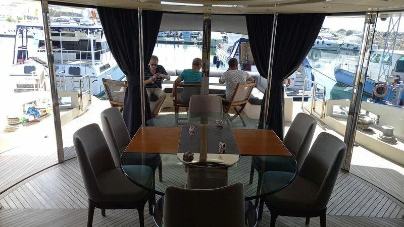 a restaurant with a table and chairs aboard AEGINA Yacht for Sale