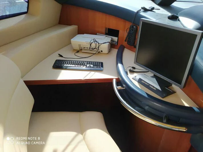 a desk with a computer and a keyboard on it aboard AEGINA Yacht for Sale